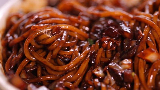 Deliciously mixed savory noodles in thick black bean sauce