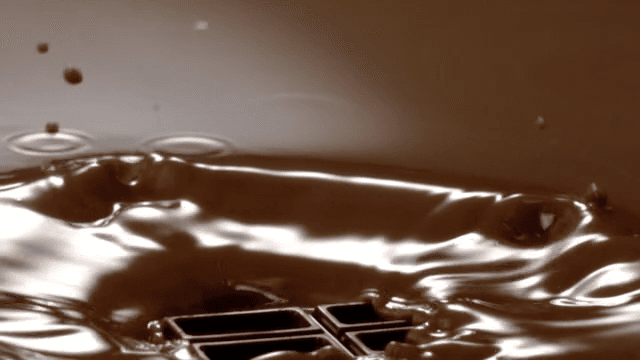 Chocolate pieces falling into chocolate fondue