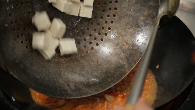 Mapo tofu, made by adding tofu to a sauce cooked in a wok