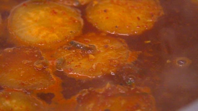 Braised fish and radish boiling in a pot