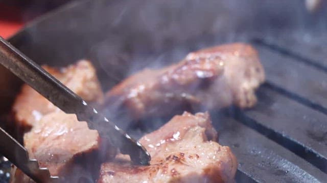 Grilling pork belly on a restaurant grill