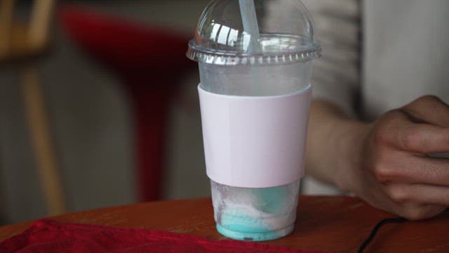 Plastic Cup with Leftover Drinks on the Table