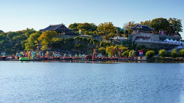 Colorful lanterns floating on the river below Jinjuseong Fortress