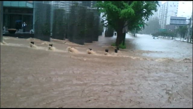 Flooding streets amidst urban buildings