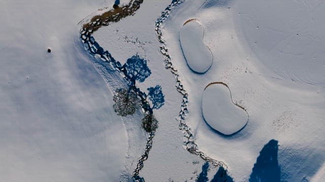 Snowy Landscape with Ponds and Trees