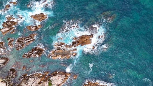 Waves crashing on rocky shoreline