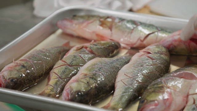 Fresh fish prepared on a knife sheath or tray