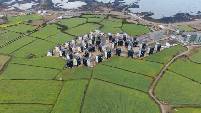 Coastal village surrounded by green fields