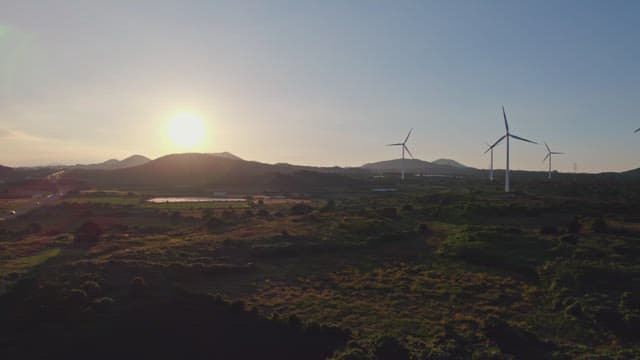 Wind turbines in a scenic landscape at sunset