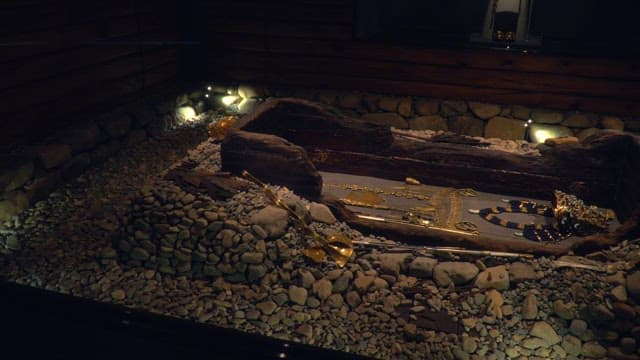 Ancient artifacts in a museum displayed under dim lighting