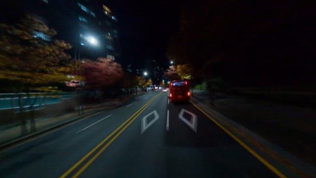 Nighttime City Street Scene with Passing Buses