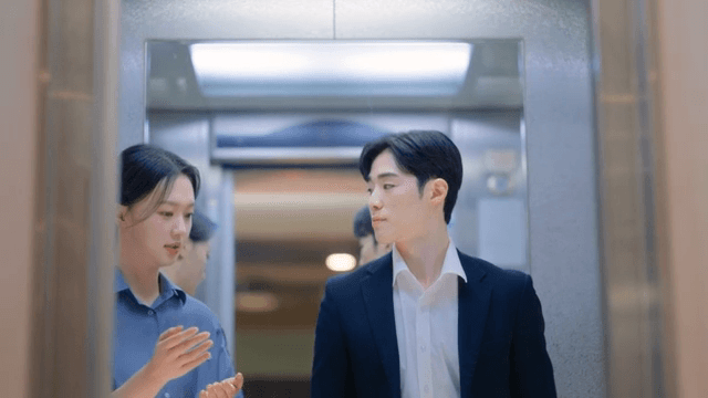 Two people talking in an elevator