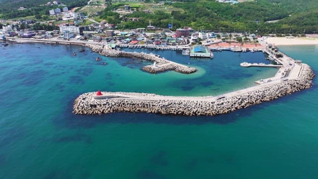 Coastal village with a lighthouse and pier