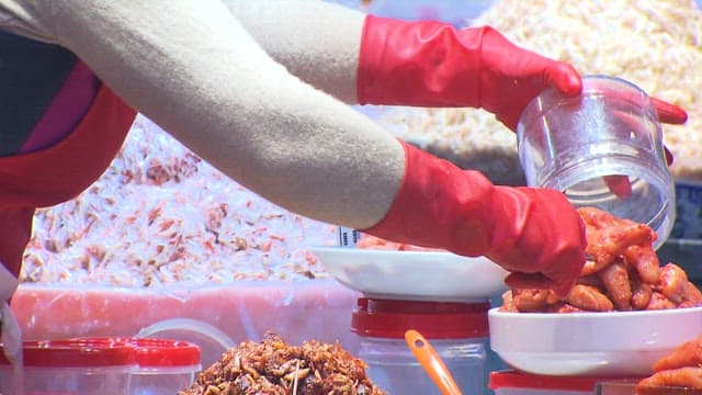 Market Vendor Putting Salted Pollack Roe in a Plastic Bowl