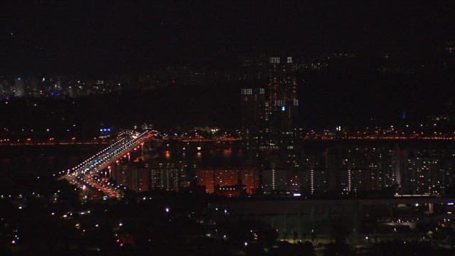 Nighttime Cityscape with Illuminated Bridge