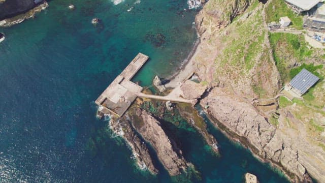 Rocky coastline with a small pier