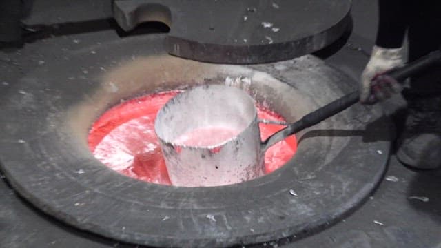 Pouring molten iron at high temperature in a foundry