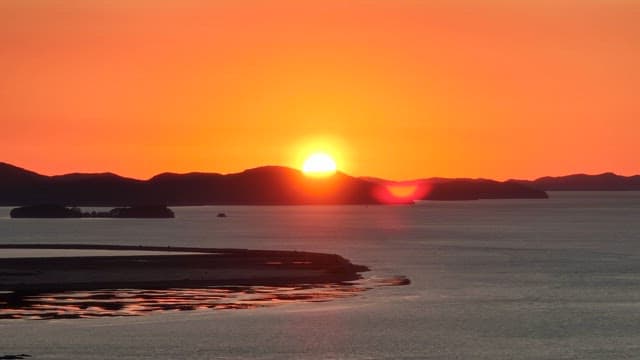 Sunset over the ocean with islands