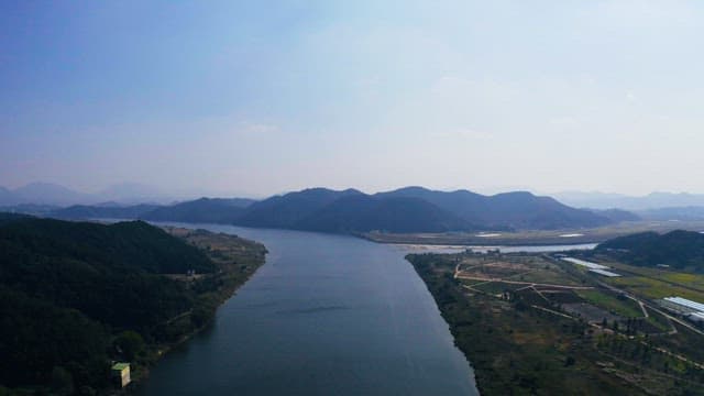 Rivers flowing against the backdrop of green forests and mountains