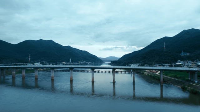 Bridge over a river with mountains