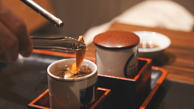 Person who prepares a cup of sake