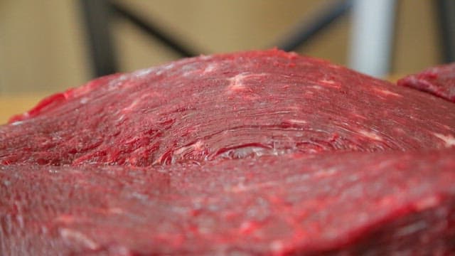Raw beef on a wooden cutting board