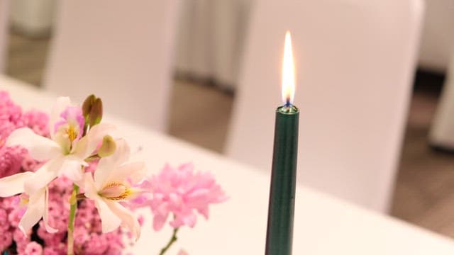Candle Flame with Flowers on a Table