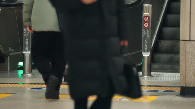 People on an escalator in a busy subway station