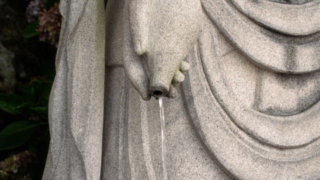 Water flowing from a stone statue
