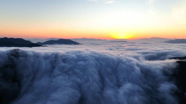 Sunrise over clouds and mountains