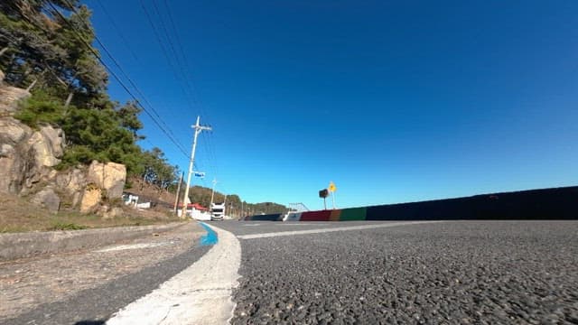 Camper Van Driving through a Scenic Road with Trees and Open Sky