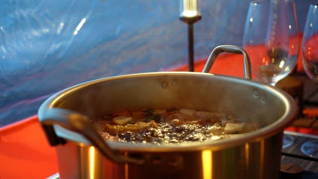 Fish cake soup inside the tent is boiling deliciously in a pot