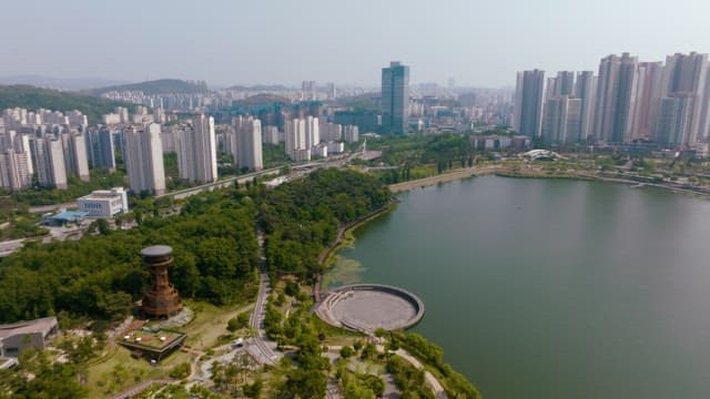 Aerial view of a city with a lake and skyscrapers