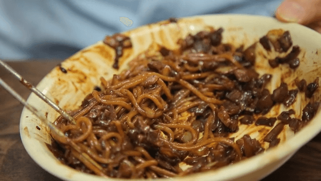 Mixing jajangmyeon in a bowl