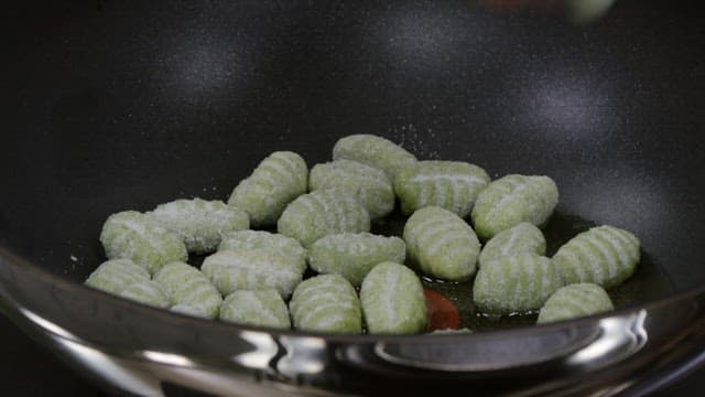Gnocchi dough cooked on a heated frying pan