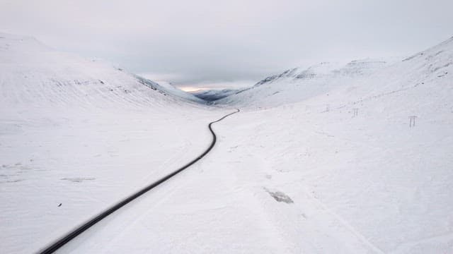 Winding road through snowy mountains