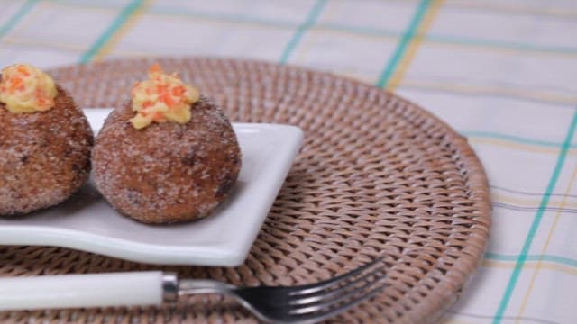 Glutinous rice donut made of carrot on a plate and a fork