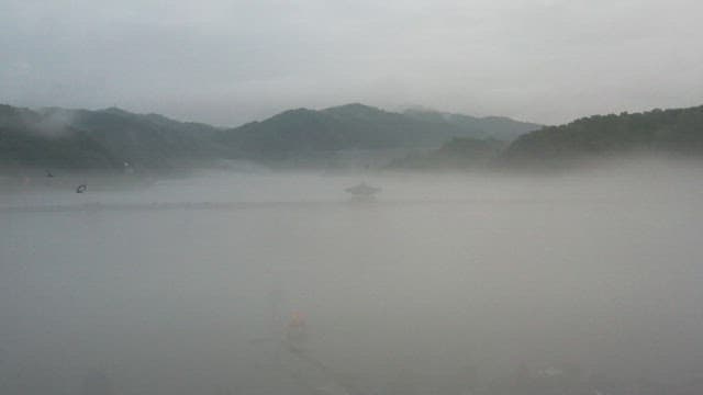 Misty Lake Scene with Traditional Pavilion