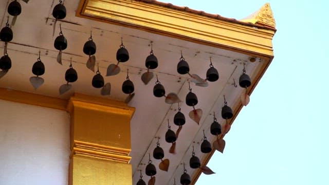 Golden temple bells swaying in the wind