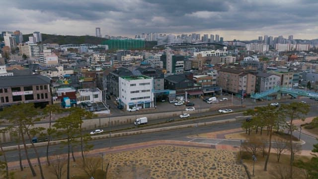 Aerial view of a city with buildings, roads and Hwaseong Fortress