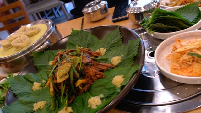 Table in a restaurant with a variety of food and side dishes