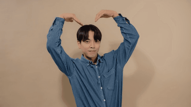 Man making heart with his arms to express his love