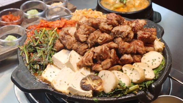 Freshly Grilled Meat and Vegetables on a Plate at a Cozy Restaurant