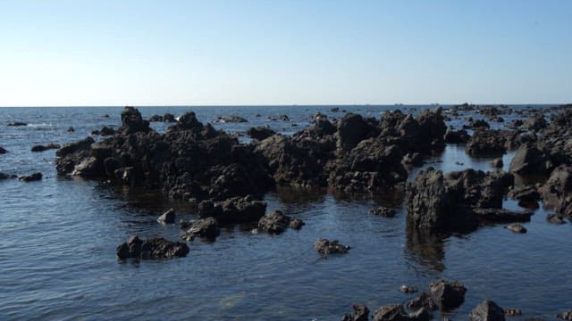 Beach filled with basalt, formed by hardened lava