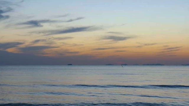 Tranquil seascape at dusk with distant islands