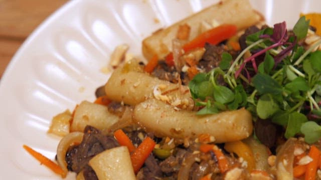 Appetizing royal tteokbokki served on a white plate