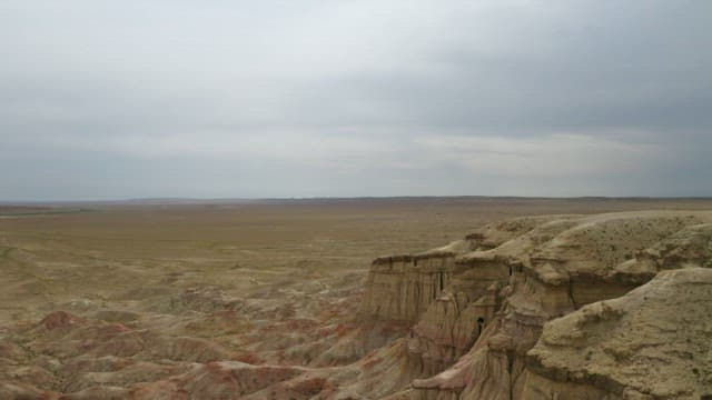 Expansive Badlands Under Overcast Skies