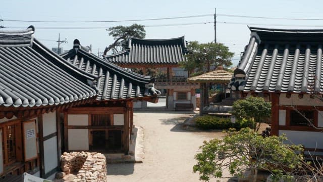 Traditional Korean Hanok Village Under Blue Sky