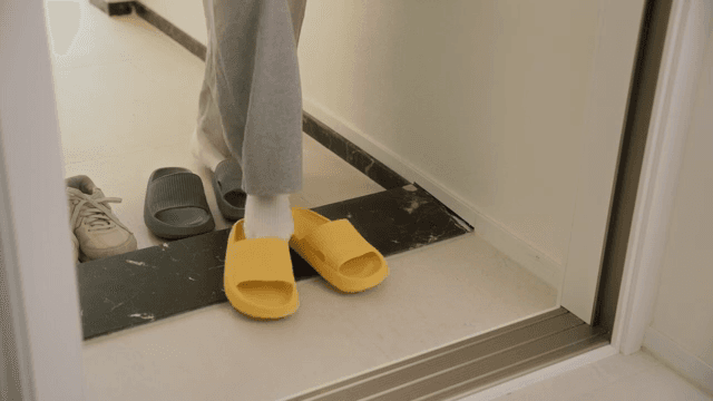 Changing slippers at the apartment entrance