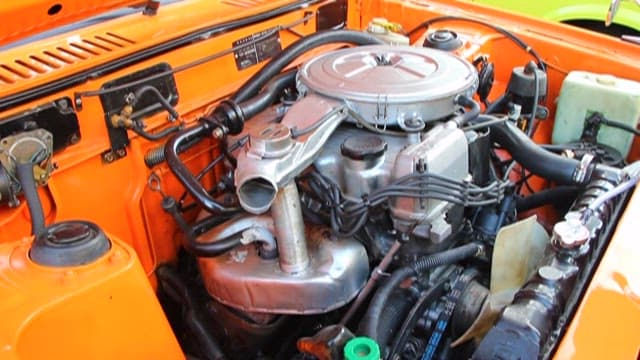 Maintenance Work on Orange Vehicle Engine